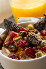 healthy breakfast oatmeal with dried  fruit and nut toppings