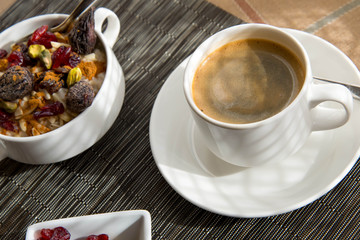 coffee and oatmeal with fruit and nuts breakfast setting