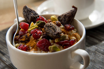 coffee and oatmeal with fruit and nuts breakfast setting