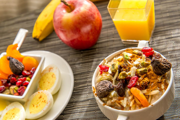 Fresh fruit and oatmeal with healthy toppings for breakfast