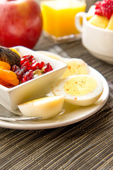 Sliced hard boiled eggs and fruit nutricious breakfast