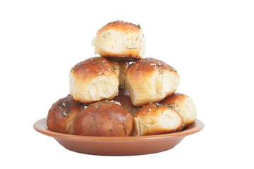 freshly baked rolls lying in the ceramic dish isolated on white