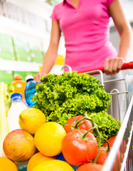 Shopping cart filled with vegetables and fruit