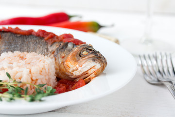 Steamed sea bass in tomato sauce with chili pepper.