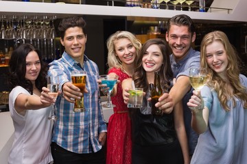 Happy friends having a drink together