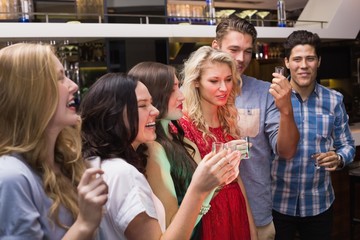 Happy friends having a drink together