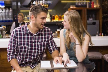 Fototapeta premium Young couple discussing the menu