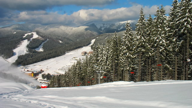 mountains, panorama down to ski lifts and snow gun, timelapse