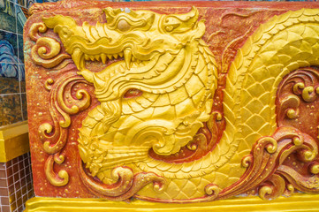 Golden dragon sculpture on wall of the sanctuary