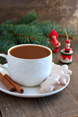 Obraz na płótnie Canvas Tea with milk and cinnamon and Christmas decor