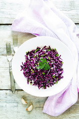 salad of red cabbage with onions and greens