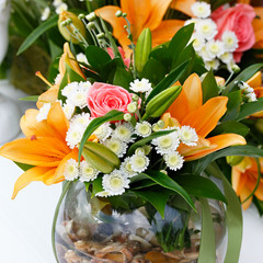beautiful bridal bouquet of lilies and roses at a wedding party