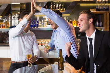 Handsome friends having a drink together