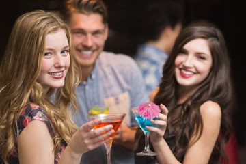 Happy friends having a drink together