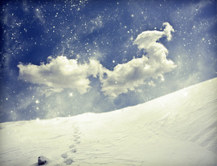 Winter landscape with snow covered hill and blue sky