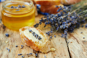 Obraz na płótnie Canvas Bread and jar of honey with lavender flowers