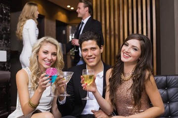 Happy friends having a drink together