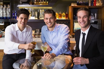Handsome friends having a drink together