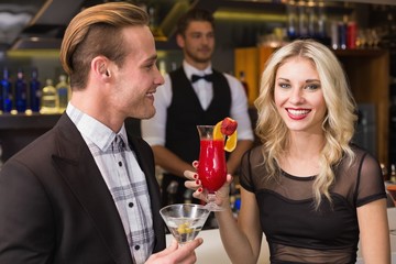 Attractive friends drinking cocktails together
