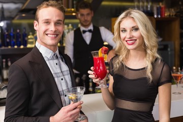 Attractive friends drinking cocktails together