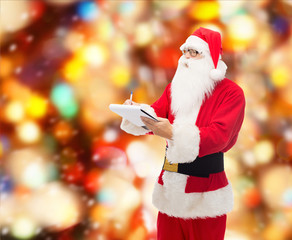 man in costume of santa claus with notepad