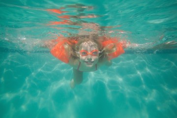 Cute kid posing underwater in pool