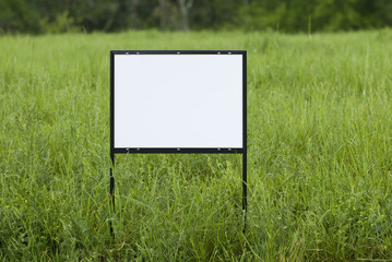 Blank Sign In Overgrown Field