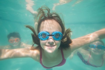 Cute kids posing underwater in pool