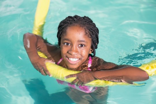 Cute little girl swimming in the pool