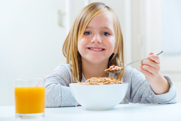 Beautiful child having breakfast at home. © nenetus