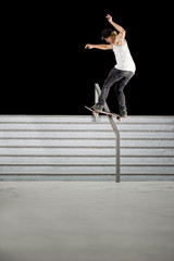boy doing skateboard trick on rail