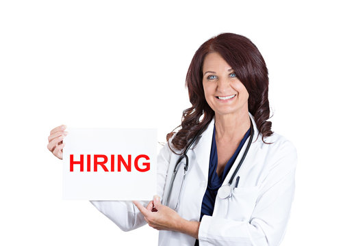 female medical doctor or nurse showing hiring sign on white