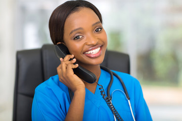 african medical doctor talking on telephone