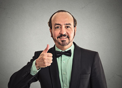 Headshot middle aged businessman giving showing thumbs up