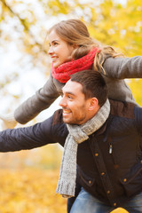 Fototapeta premium smiling couple having fun in autumn park