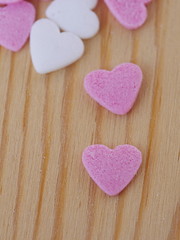Naklejka na ściany i meble candy hearts wood background