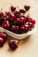 Fresh cherries in bowl on table