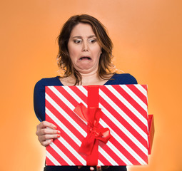 woman opening gift box upset at what she received disgusted 