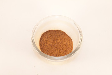 Cinnamon powder, in a glas pot