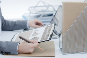 Businessman analyzing investment charts with laptop. Accounting