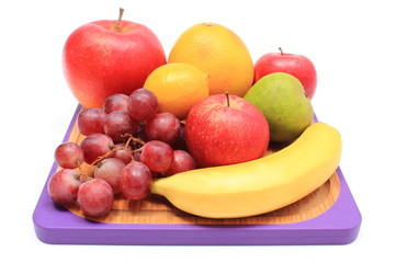 Fototapeta na wymiar Fresh natural fruits on cutting board