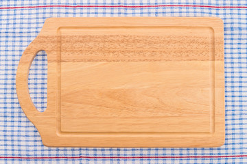 wood cutting board on tablecloth
