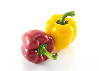 Red and yellow peppers solated on white