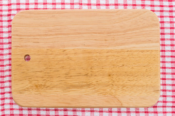 wood cutting board on tablecloth