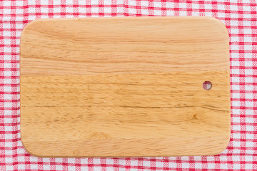 wood cutting board on tablecloth