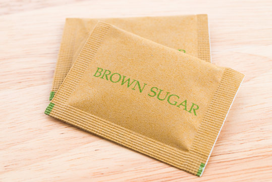 Brown Sugar Bag On Wood Background