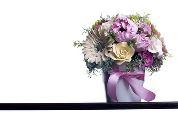bouquet of flowers on a brown desk with isolated background