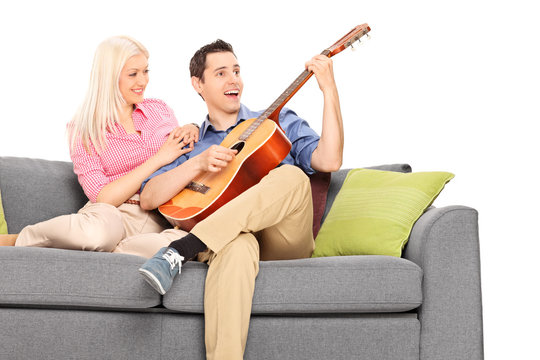 Young Guy Playing Guitar With His Girlfriend