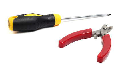 small pliers and a flat screwdriver long on a white background