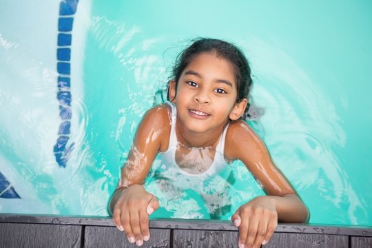 Cute little girl smiling in the pool